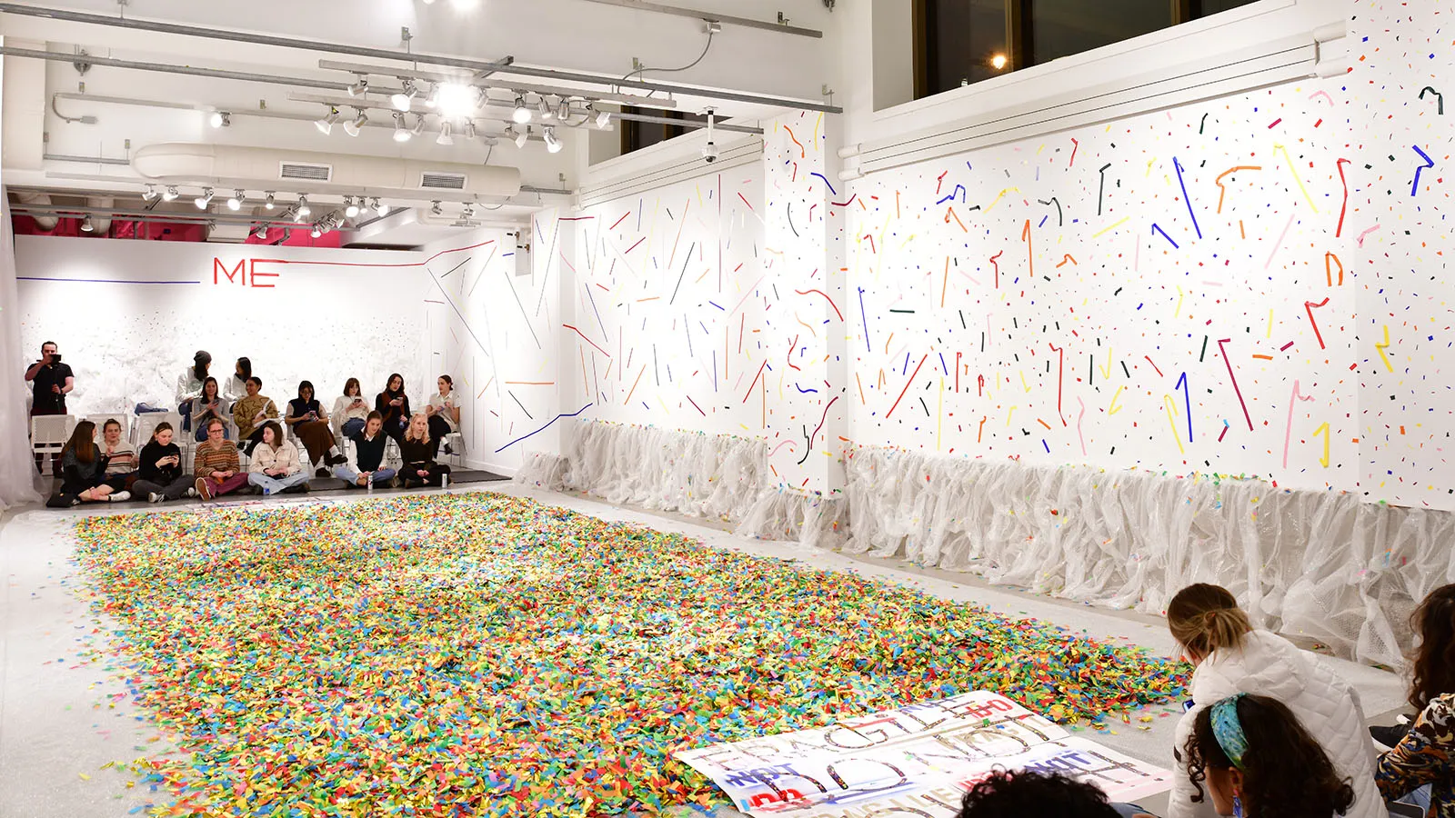 gallery view of people gathered waiting for performance to start.
