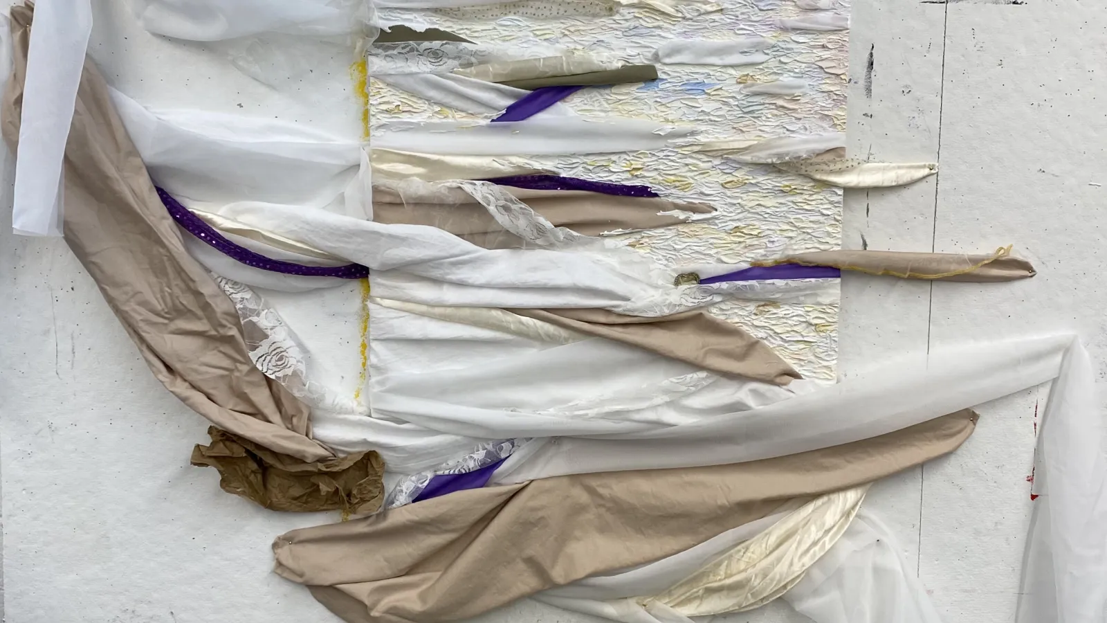 Fabric art piece by Madeline with purple, white, and beige fabric