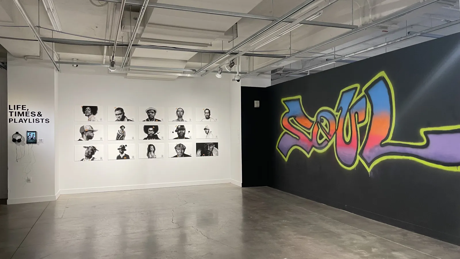 Wall featuring the word Soul in graffiti; opposite wall features digital drawings of famous Black artists