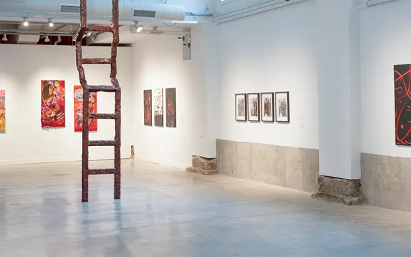 Ladder installation and paintings in gallery space