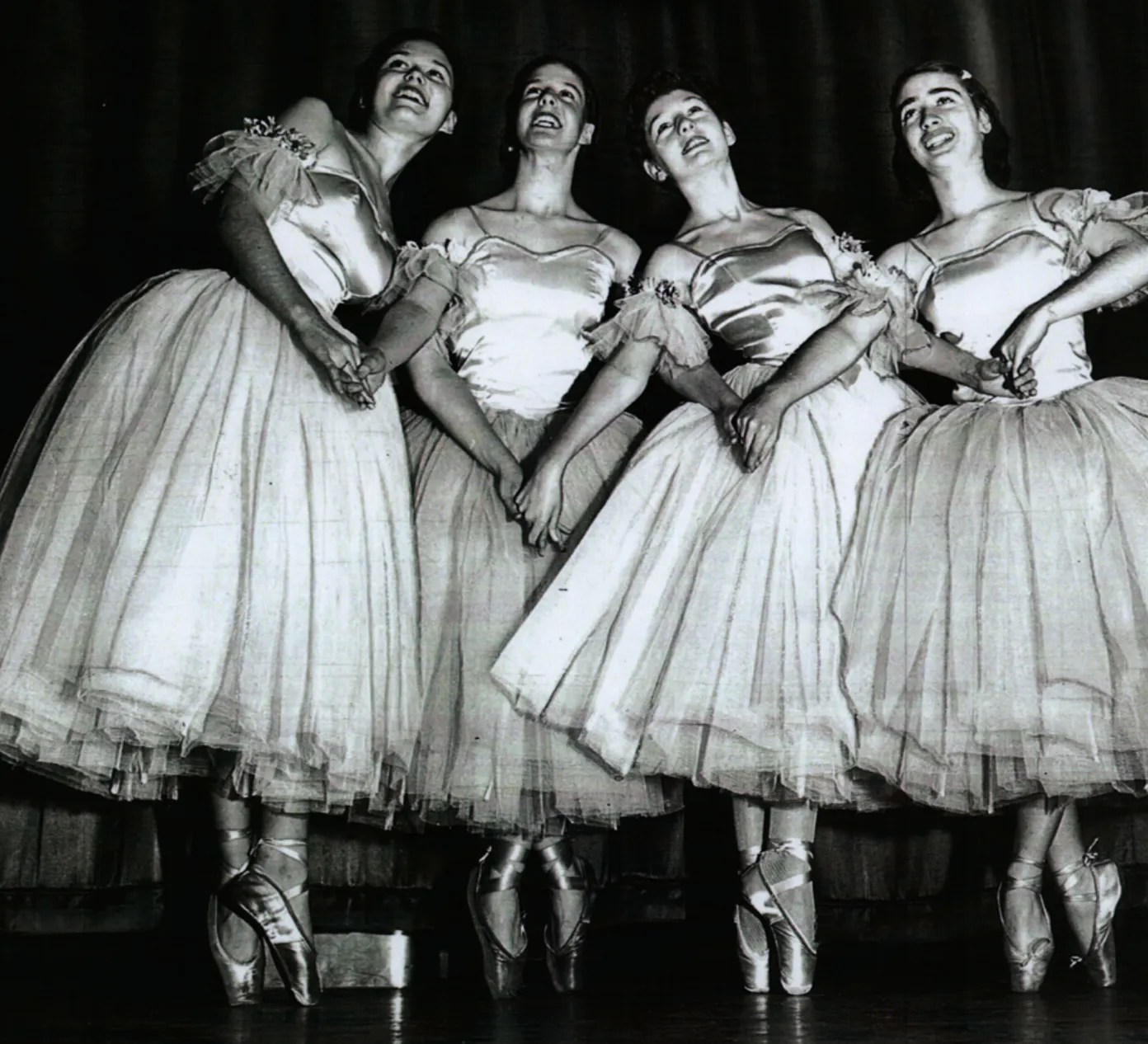 four dancers in white tutus
