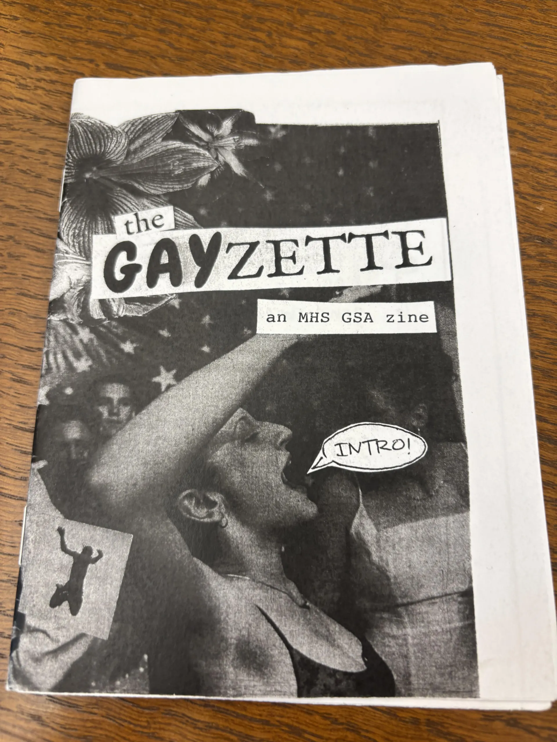 "The Gayzette" an MHS GSA Zine Intro. The zine features a collaged cover of a figure yelling with flowers and flags behind them.