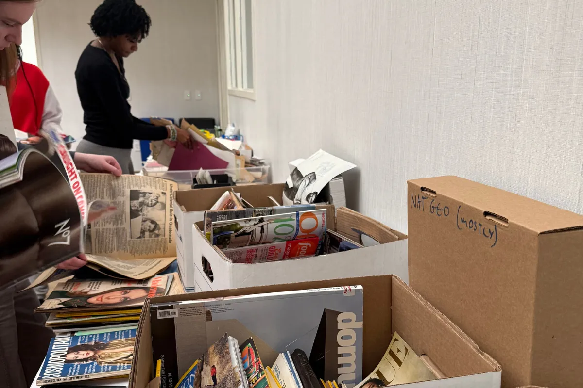 people browsing boxes of magazines