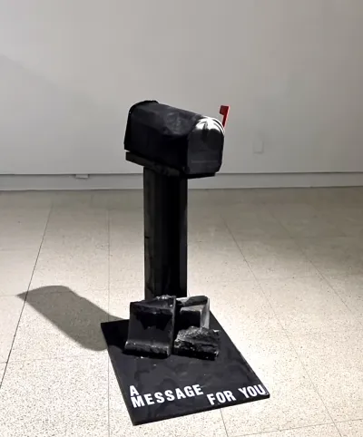 A black mailbox with text that says A Message for You