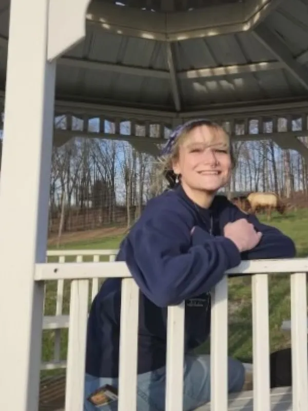 Photo of Maya Mercer sitting outside.
