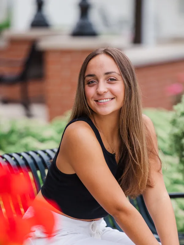 Morgan sitting on a bench and smiling