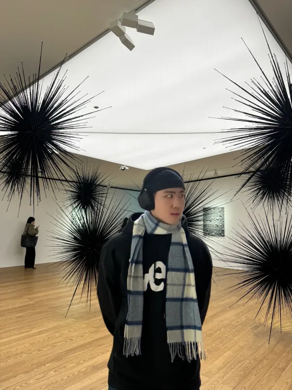 Ukheon standing in front of an art installation.